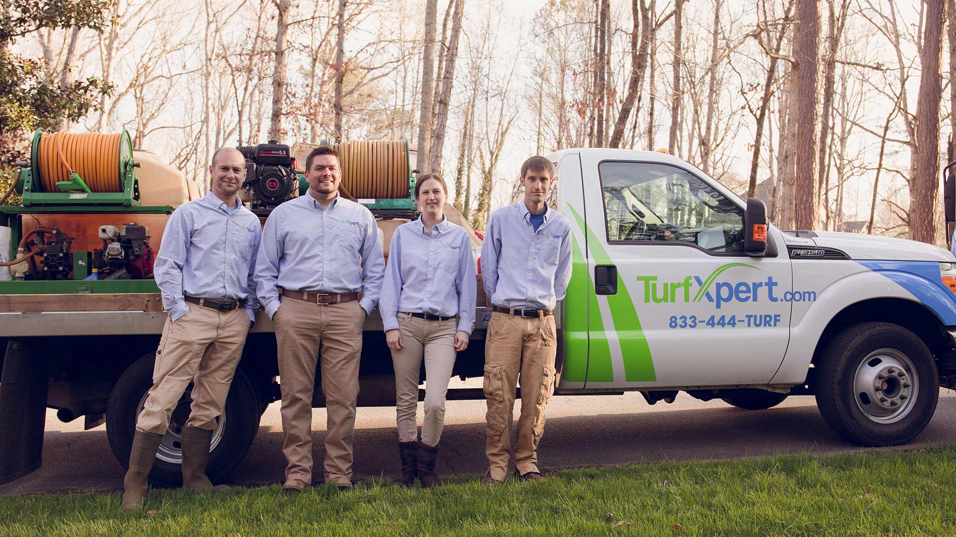TurfXpert staff and work truck servicing a Woodstock, GA lawn.