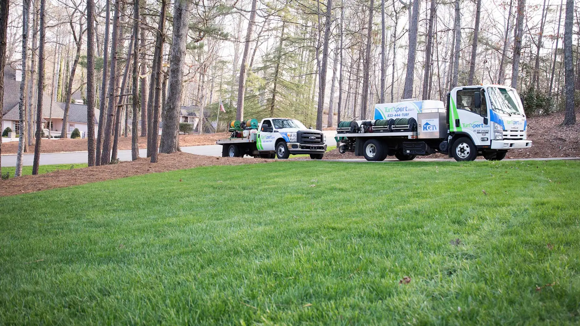 TurfXpert work vehicles arriving to perform lawn care treatments in Kennesaw, GA.