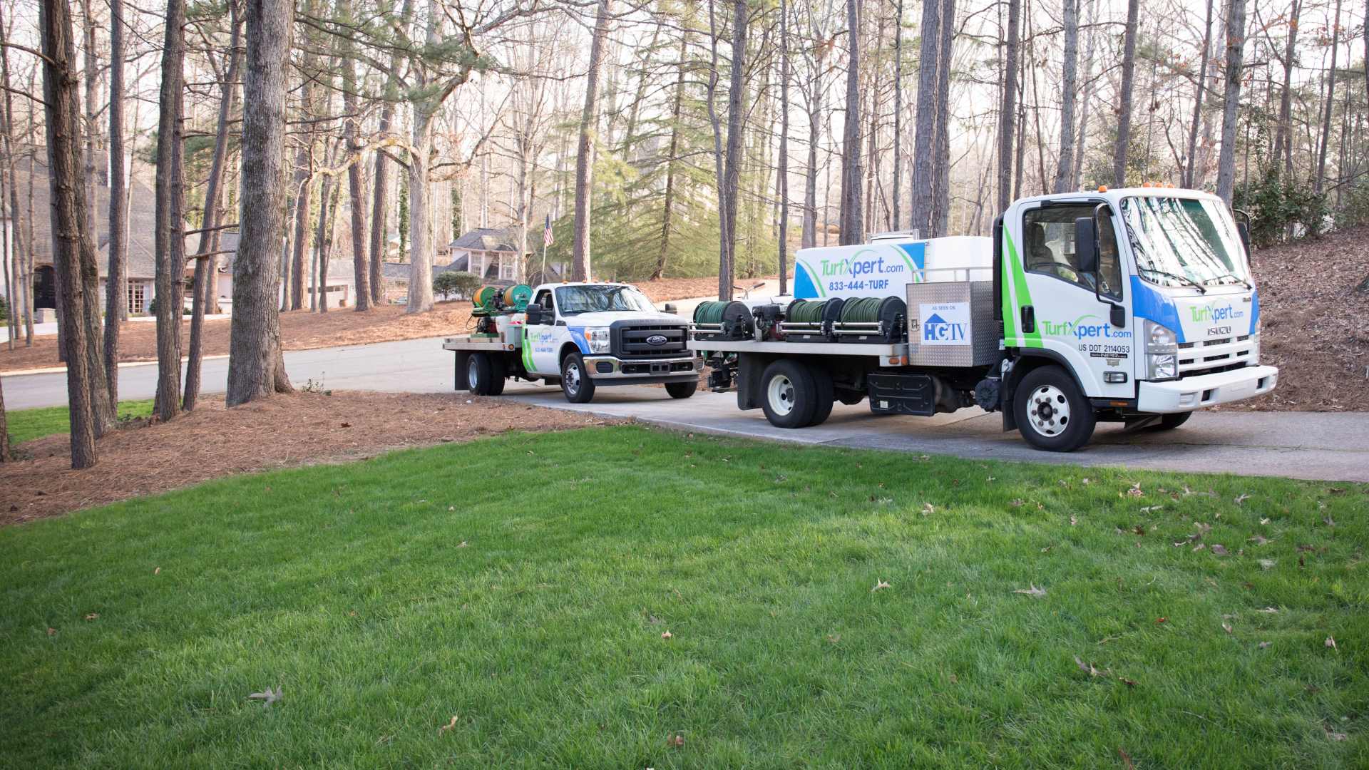 TurfXpert work trucks displayed in driveway in Sugar Hill, GA.