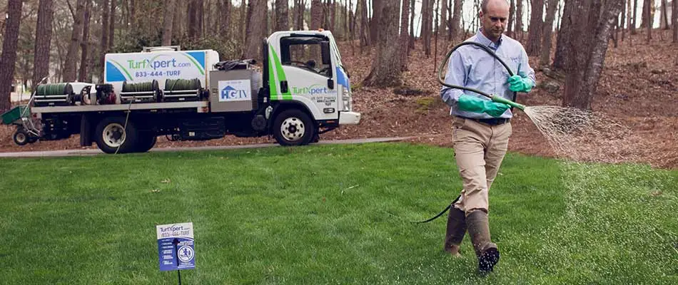 TurfXpert lawn care expert fertilizing a home lawn in Roswell, GA.