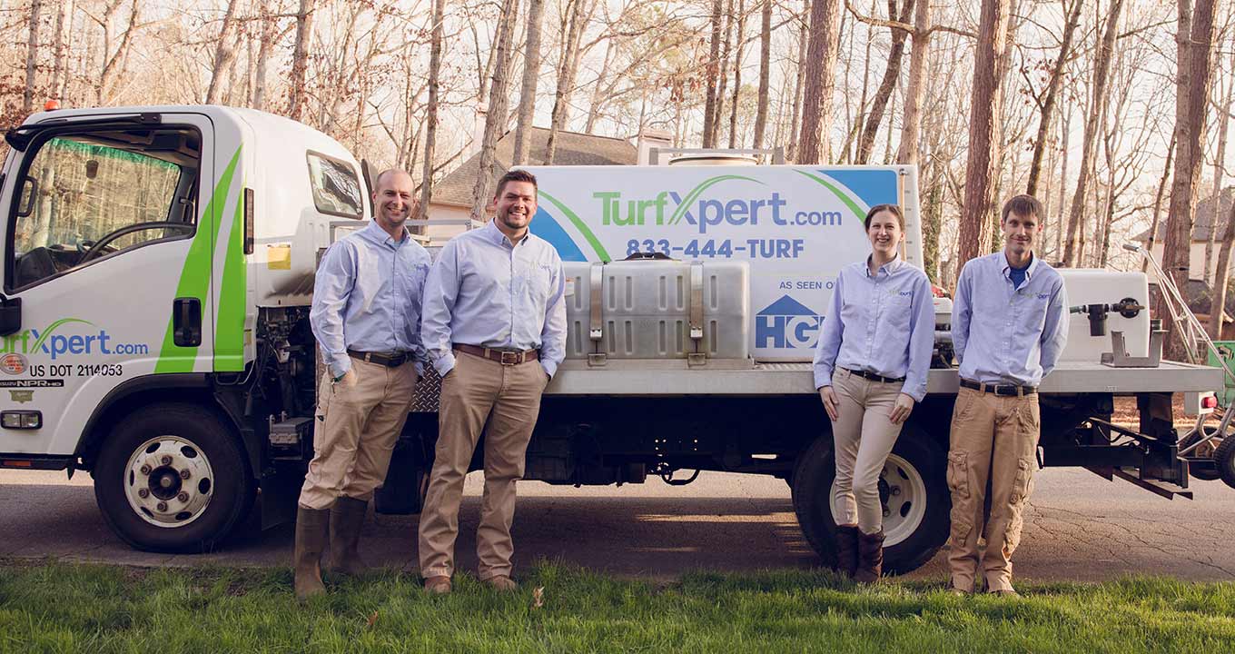 The TurfXpert staff and work truck with company name and number in Woodstock, GA.