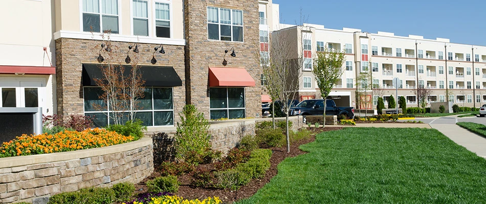 An apartment complex with a stunning curb appeal with its landscaping and healthy lawn.