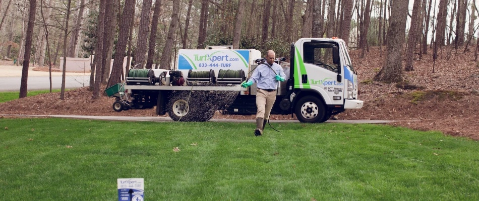 Professional from TurfXpert applying pre-emergent weed control to lawn in Woodstock, GA.