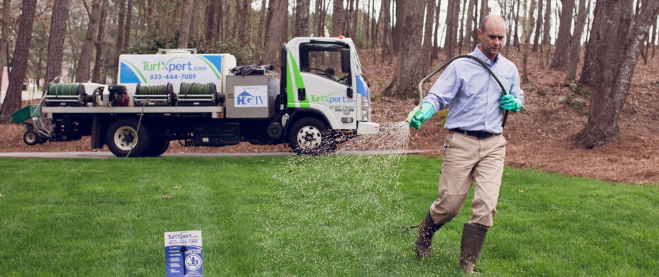 Professional applying lawn treatment to a lawn in Holly Springs, GA.