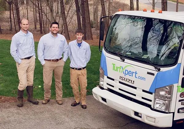 TurfXpert team by work truck.